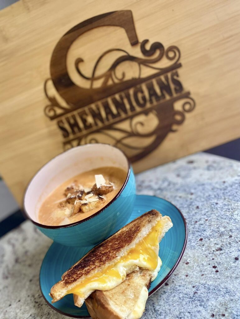 a grilled cheese and soup in front of a shenanigans sign in hazard kentucky