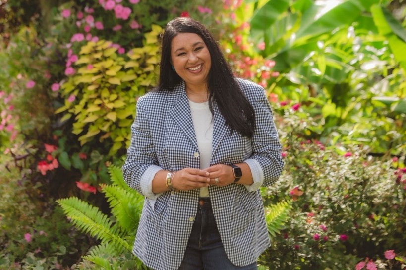Angelika weaver stands at oak hill gardens posing for her professional headshots