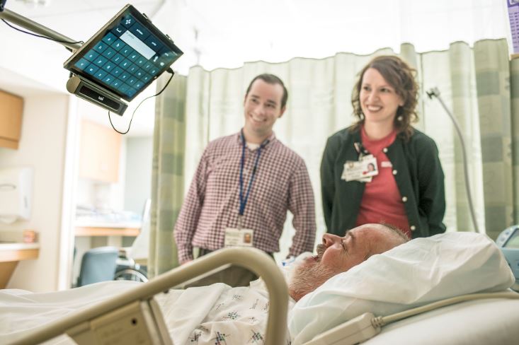 Two people stand with a patient who uses a Tobii at Rockcastle Regional to type. The rural hospital in EKY has innovative services
