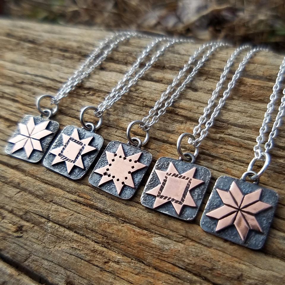 Quilt jewelry shown on display. This is a new line Fishing Creek jewelry in Somerset Kentucky. MACED support artists with business loans 