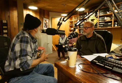 A MACED New Energy intern is at a table being interviewed about energy efficiency, solar and coal mining in eastern kentucky and appalachia