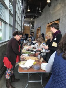 A group stands in a line for food at an event in harlan county, kentucky, for woman business owners.