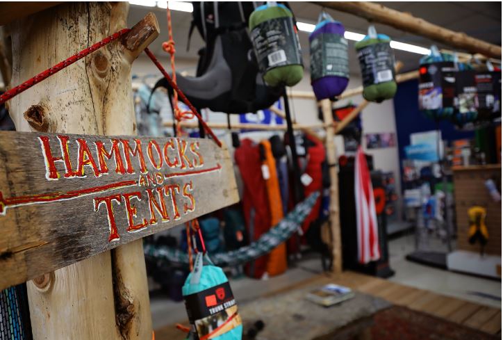 A handmade sign reads hammocks and tents. The sign hangs inside the store in Richmond, Kentucky.