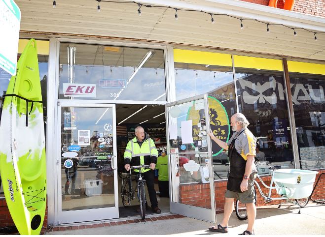 Customer leaves the shop on a bike. They try to promote a biking community in Richmond, Kentucky.