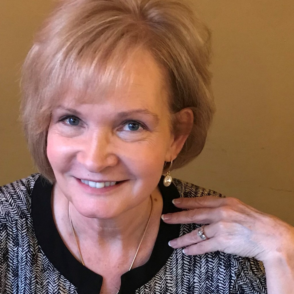 mindy woods-click smiles for a portrait. She and her husband dan click operate grayson gallery and art center in carter county kentucky.