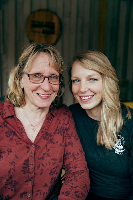 Owners of the Daniel Boone Coffee Shop & Scenic Cabin Rentals pose in front of their building in the heart of Red River Gorge - Slade, Kentucky. 