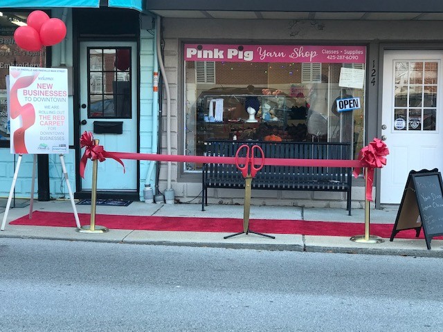 A ribbon cutting in front of Pink Pig Yarn Shop in downtown pikeville, kentucky. The shop opened in October 2020.