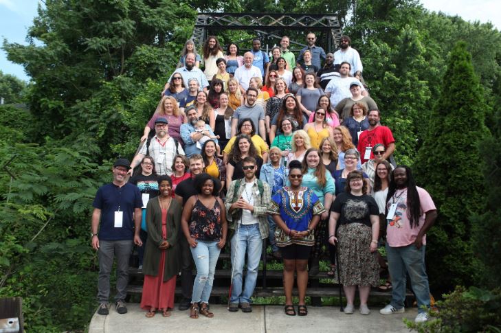 A large group stands in front of a kudzu patch in eastern kentucky. The group is from Kentucky Rural Urban exchange, or RUX