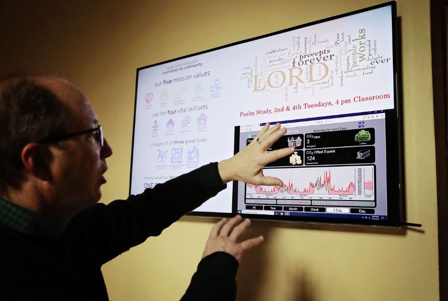 Union Church employee shows solar dashboard inside the church in Berea Kentucky. MACED helps churches go solar