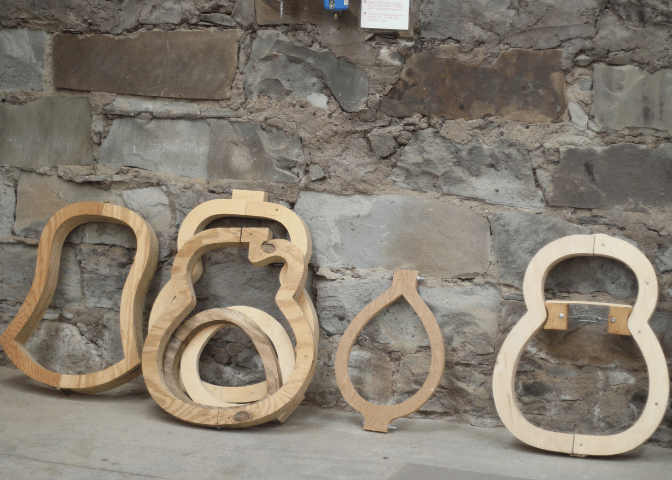 Wood models lean on a wall at the Troublesome Creek Stringed instrument company building in knott county kentucky.